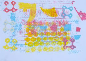 Abstract monoprint on white paper with yellow, pastel blue and pastel pink ink in circular shapes and patterns.