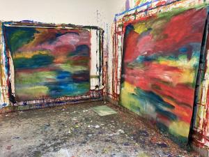 2 large multicoloured abstract paintings hanging on studio walls