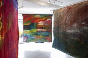 colourful abstract paintings hanging in gallery 