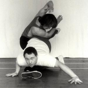 2 people dancing together. They are on the floor entwined around each other.