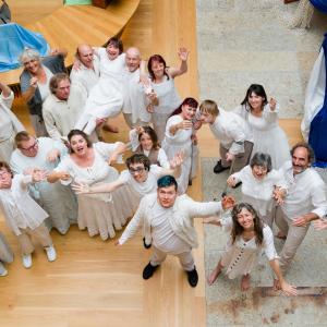 A group photo of shallal dance theatre performers wearing white