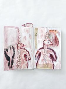 a collage and drawing in a sketchbook of a female figure with a bird head