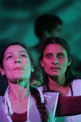 2 people performing on a green stage