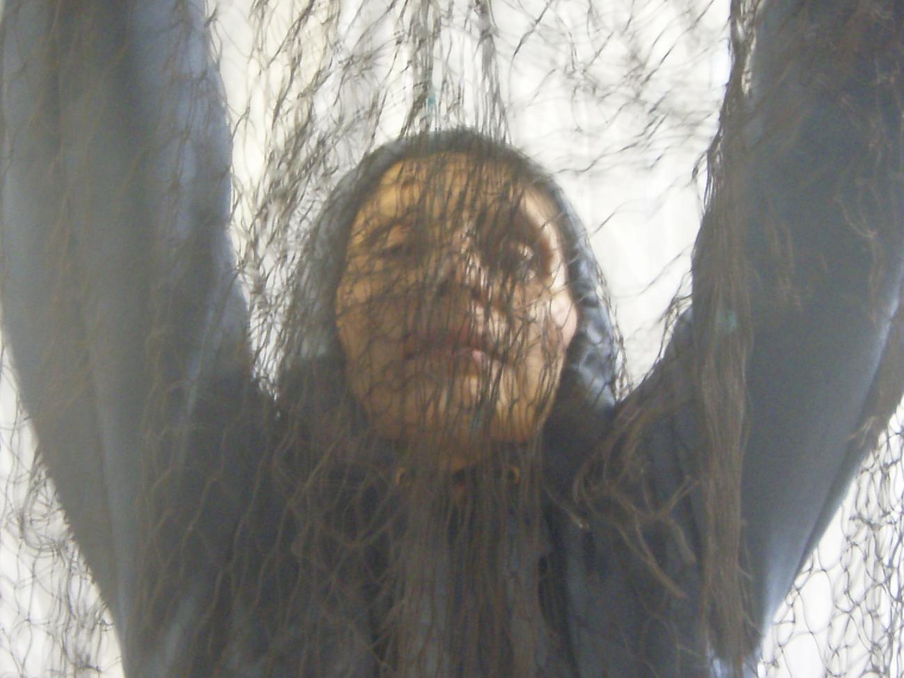 a person holding netting over their face