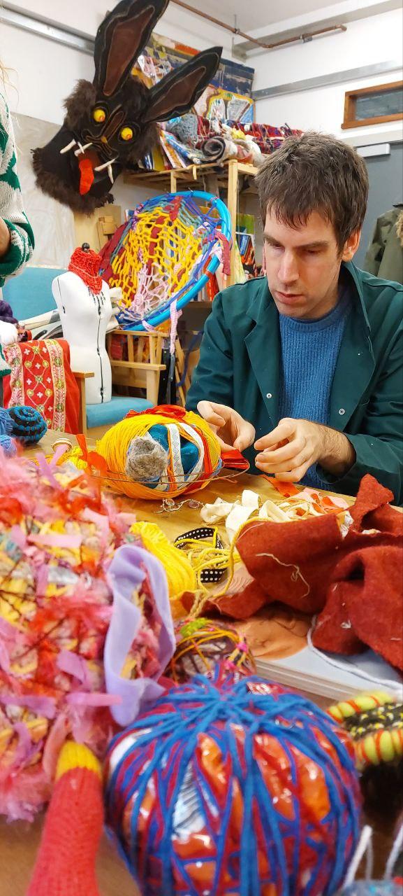 A person playing with textile materials 
